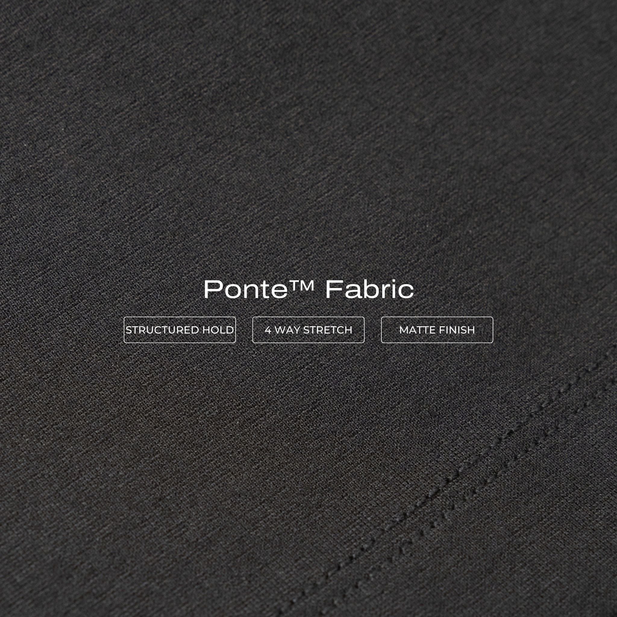 Close-up of black Ninepine Ponte fabric texture with stitching detail.